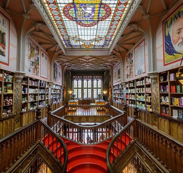 a staircase way with a red carpet and a skylight