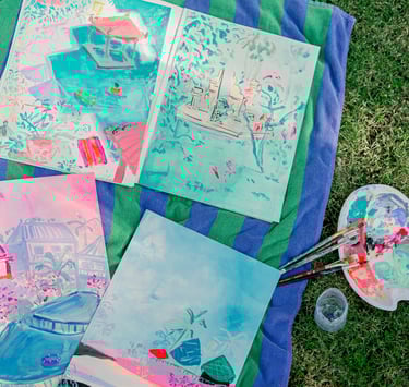 a bunch of paintings on a blanket. Sketchbooks in Bali by artist Lena Sin