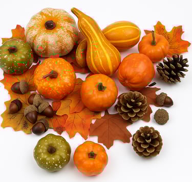 A detailed image of assorted faux pumpkins, pinecones, leaves, and acorns arranged in a cluster