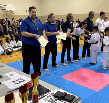 a man in a blue shirt is holding a certificate