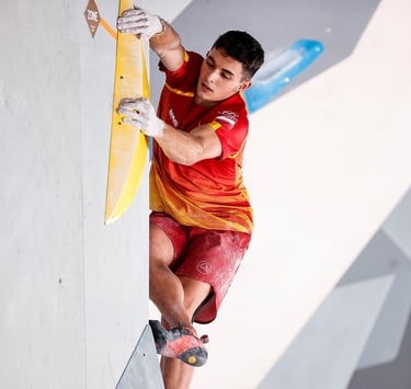 a man is bouldering on a climbing wall