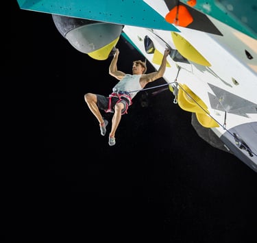 a man is lead climbing an overhanging climbing wall