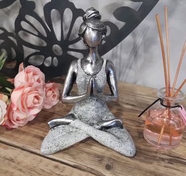 a statue of a woman sitting in a lotus position