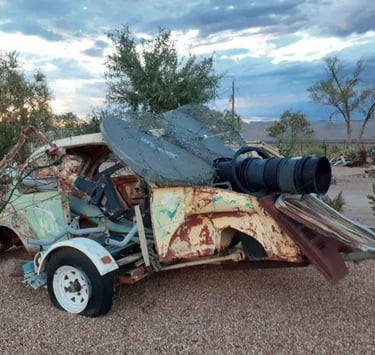 Metal art sculpture combining old VW bug parts with rat ears