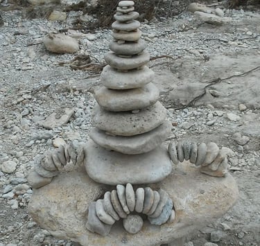 Rock sculpture arranged in a dry river bed.