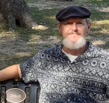 Christian brother Trace Pirtle sitting at Jesus Bench, Louise Hays Park
