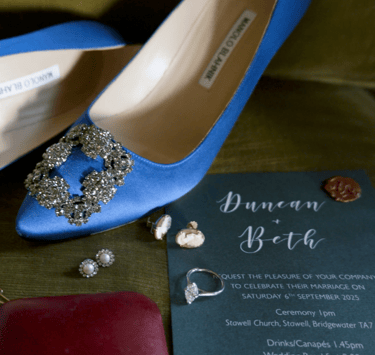 Blue wedding shoes paired with matching accessories, elegantly arranged on a soft surface, showcasing a stylish bridal look.