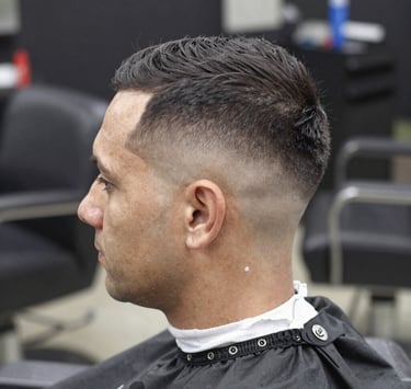 A client relaxing while receiving a detailed eyebrow shave with a straight razor.