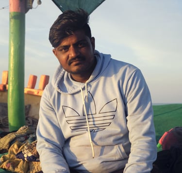 a man sitting on a blanket in a tent