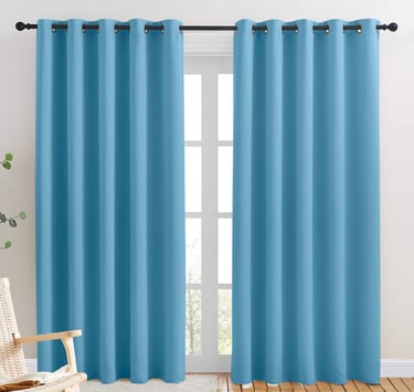 a blue curtain with a chair and a rocking chair