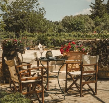 a table with chairs and a table with a vase at dourakis winery