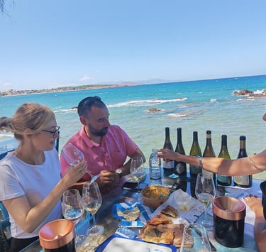 a group of people sitting at a table with greek wine during wine tasting