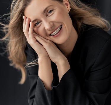 a woman with blonde hair and a black jacket