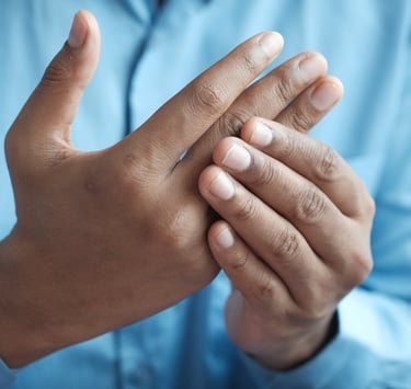 Man holding his hands, because of his arthritic pain.