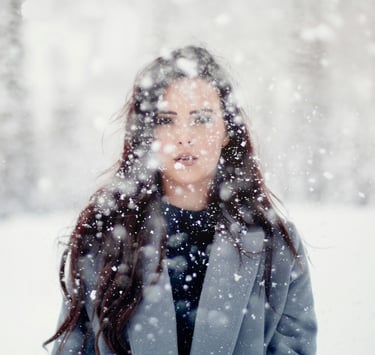 Young woman in the snow, appearing in pain.