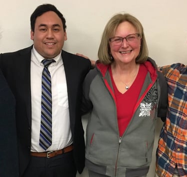 Former Tongass Democrats officers smiling, with their arms around each other