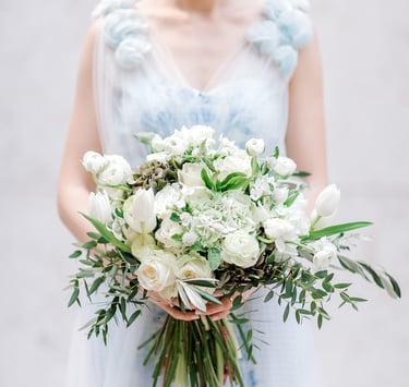 Beautiful bride in Karen Rodrigues gown holding flower bouquet