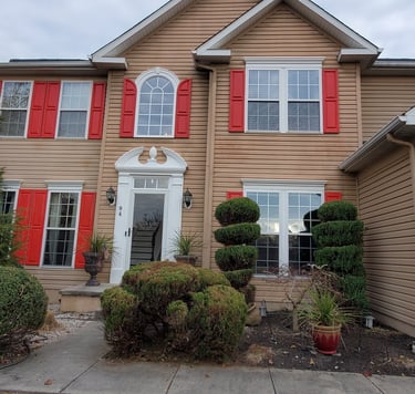 a house with red shutter shutters and red shutters