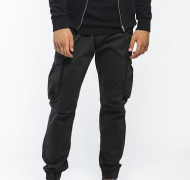 a man in a black hoodie and black pants