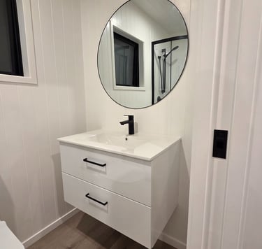 Bathroom vanity with large round mirror