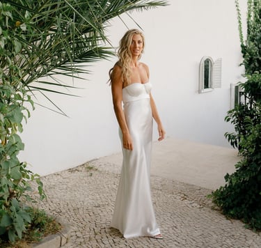 Bride in a white wedding dress with loose long hair and beach waves