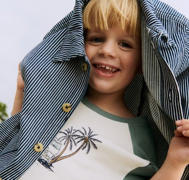Wheat SS25 campaign imagery with a blond boy with a striped shacket over his head