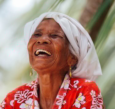 Smiling Mentawai local woman in traditional attire, embodying the warmth of island culture.