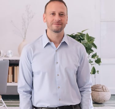 a man in a blue shirt and a laptop