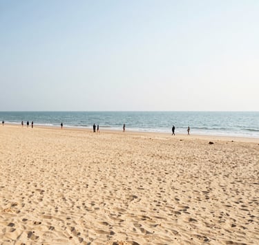 Bright wide-angle shot of Bai Chay Beach at daytime, golden sand, calm sea, people walking, natural sunlight