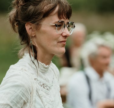 a woman in a white shirt and glasses