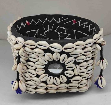"Bamboo basket wrapped in elegant black fabric with tribal-style shell detailing and floral garland-Export-oriented"