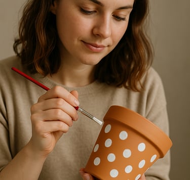 woman at hen party paint a plant pot with polka dots