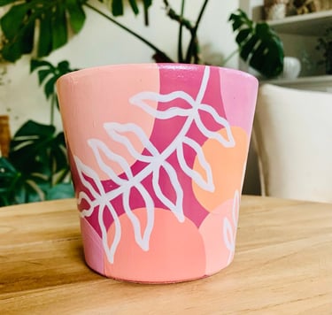group of women painting a terraccotta plant pot at a hen party workshop in York