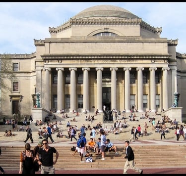 a large building with a lot of people walking up the stairs