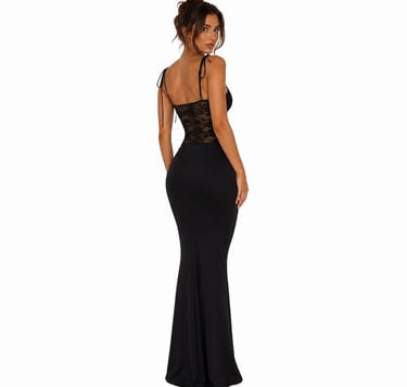 Back view of elegant black fitted maxi dress with lace waist detail and minimal evening aesthetic.