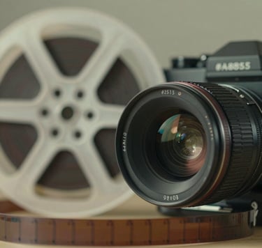 A close-up of a vintage film reel and a modern camera lens, subtly illuminated with #A88B57 light, symbolizing the bridge between classic cinema and contemporary production.
