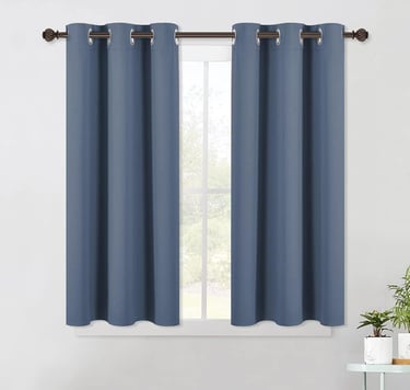 a curtain with a blue curtain and a potted plant