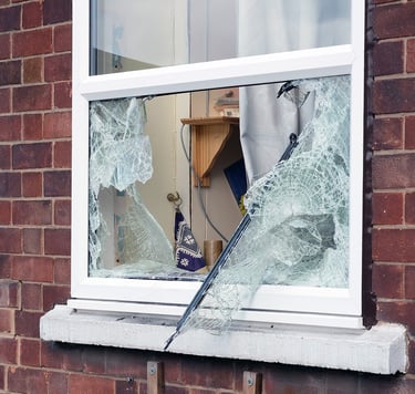 damaged glass in window due to break-in