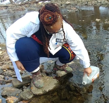 Shenell is collecting water samples for an environmental assessment