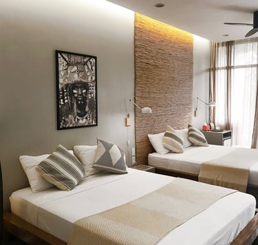 a bedroom with two beds and a ceiling fan