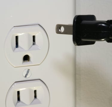 A device being unplugged from electric socket