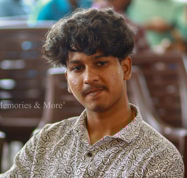 a man with a curly haircut and a flowered shirt
