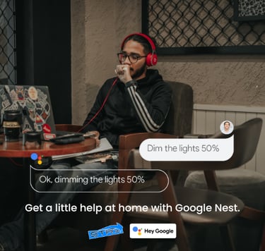 a man sitting at a table with a laptop and headphones