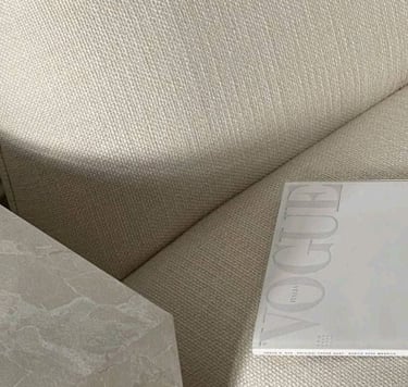 Soft neutral-toned fabric with a Vogue magazine, representing brand aesthetics and style.