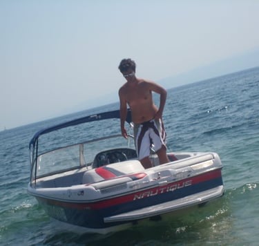 a man standing on a boat in the ocean
