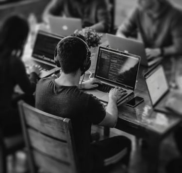 high vw of a group of people working at an office, seating on their desks
