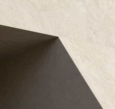 A minimalist architectural detail of a sharp corner where soft sand-colored stone (#F9F7F2) meets deep charcoal shadows (#333333). Minimalist and clean aesthetic.