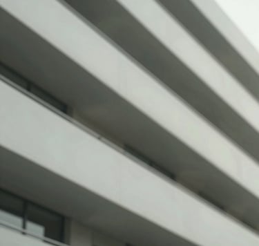 An understated, elegant detail of a modern architectural structure with soft, natural shadows. Incorporates muted tones of #3F5E5C and #A7C5C3. Crisp, clean lines and professional composition.