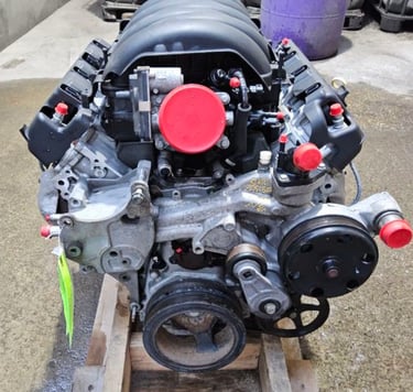 Rebuilt LS V8 engine assembly on a wooden pallet for automotive performance upgrades.