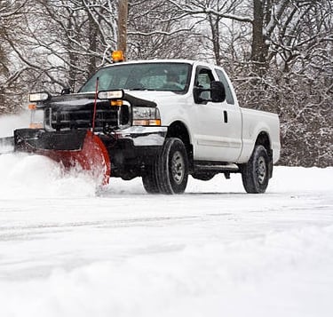 removing snow with plow